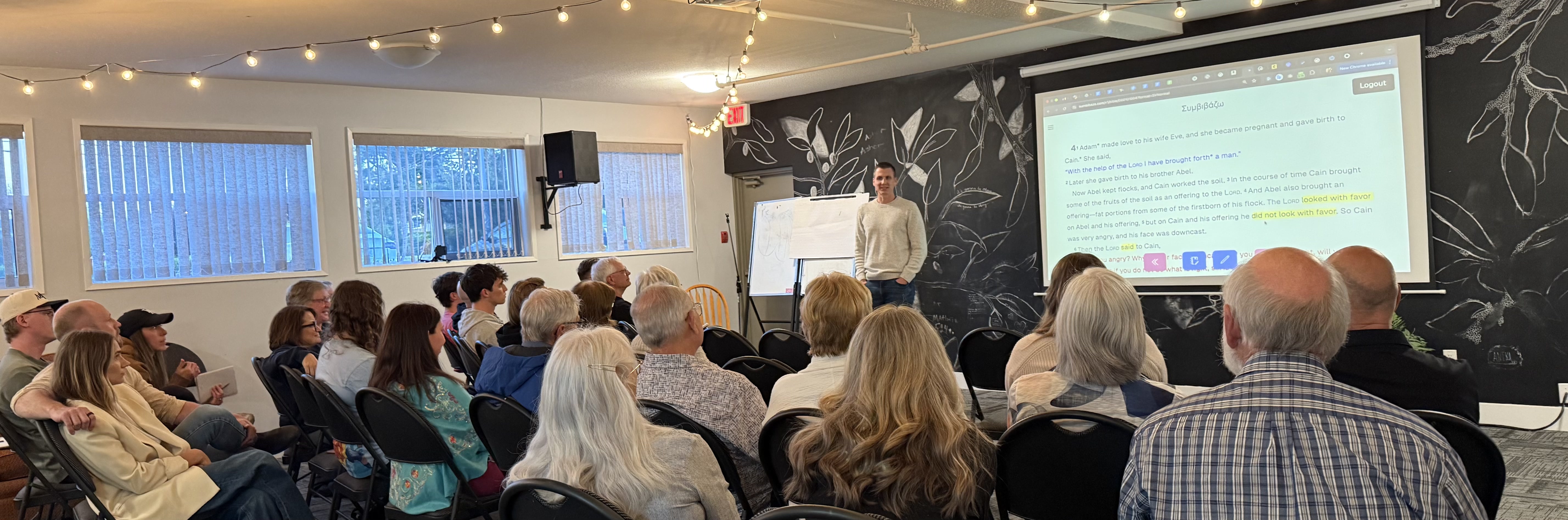 Rob teaching the Bible to a large seated group